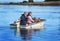 Couple with dog on small boat