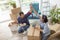 Couple doing high five after packing boxes while moving house