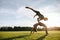 Couple doing pair yoga in park