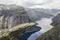 Couple doing titanic on trolltunga troll`s tongue rock , Norway