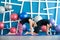 Couple doing yoga in a studio. Young people in yoga class in Cat pose. Yoga group concept