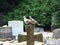 Couple of doves sitting on stone cross in cemetery