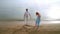 Couple draw heart symbol on sand. Romantic couple drawing heart shape on beach