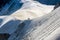 Couple dressed mountaineering clothes with backpacks rising arms with ice axes and enjoying views on the summit top near Aiguille