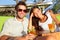 Couple drinking alcohol at beach club having fun