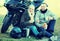 Couple drinking coffee near motorcycle