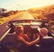 Couple Driving Convertable at Sunset