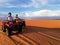 Couple driving quads in the sahara desert