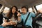 Couple Driving Using Cellphone Sitting In New Automobile