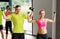 Couple with dumbbells exercising in gym