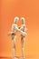 Couple of Dummies hugging each other on an orange background. Friendship concept