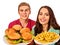 Couple eating fast food. Man and woman eat hamburger