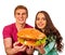 Couple eating fast food. Man and woman treat hamburger .