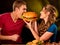 Couple eating fast food. Man and woman treat hamburger .