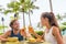Couple eating at hotel restaurant on Hawaii travel vacation beach drinking hawaiian drink mai tai. Happy people toasting