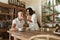 Couple Eating At Kitchen Table. Woman Feeding Vegetarian Food To Man. Family Lunch In Villa At Tropical Resort.