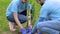 Couple of eco volunteers planting tree and smiling, save nature project, ecology