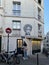 Couple embraces on Montmartre, under wall art portrait of woman`s head, Paris, France