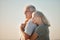 couple embracing on the beach. Mature couple enjoying the view on the beach. Senior couple bonding on the beach. Mature