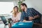 Couple embracing and paying household bills or taxes on laptop online at home