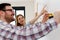 Couple in empty apartment measuring walls for decorating