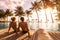 Couple enjoying beach vacation holidays at tropical resort with swimming pool and coconut palm trees near the coast with beautiful