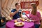 Couple Enjoying Breakfast Whilst Camping In Traditional Yurt