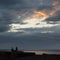 Couple enjoying a dramatic sunset