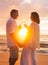 Couple Enjoying Glass of Champene on the Beach at Sunset