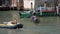 A Couple Enjoying a Gondola Ride in Venice, Italy as Motorboats Pass Very Close By