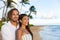 Couple enjoying Hawaii vacations on hawaiian beach. Portrait of beautiful Asian chinese woman and Caucasian man happy