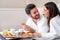 Couple enjoying hotel room service.