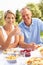 Couple Enjoying Meal In Garden