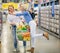 Couple enjoying shopping at the supermarket. Woman is about kissing a man