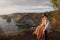 Couple enjoying view from Banah Cliff of Nusa Penida island, Indonesia