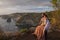 Couple enjoying view from Banah Cliff of Nusa Penida island, Indonesia