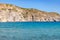 Couple enjoying waves and cliffs in  Firopotamos beach