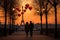 A couple enjoys a leisurely walk down the sidewalk with the iconic Eiffel Tower as their bac