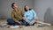 Couple enjoys room renovation sitting on parquet floor