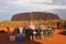 Couple enjoys the sunset at Ayers Rock and has a picknick, Australia