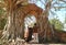 Couple Entering the Amazing `GATE OF TIME` of Wat Phra Ngam Temple Ruins in Ayutthaya, Thailand