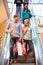 Couple On Escalator In Shopping Mall Together