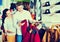 Couple examining various coats in sports store