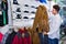 Couple examining various coats in sports store