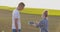 Couple on farm talking in field of green plants