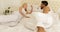 Couple feet run jump on bed mix race man woman embrace bedroom