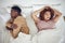 Couple fight, angry and bedroom with a black woman and man feeling frustrated in a bed. Home, conflict and relationship