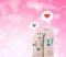 Couple finger holding flower and chat box on pink heart bokeh