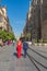 A couple of Flamenco dancer in red dress walking at the church in Seville, Andalusia, Spain, vertical