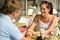 Couple flirting holding hands at cafe bar